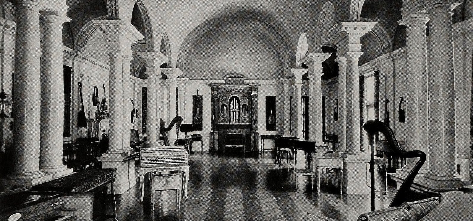 The interior of the Belle Skinner Music Room at Wistariahurst, as it appeared with her collection of musical instruments, for which it was designed, prior to their donation to beco