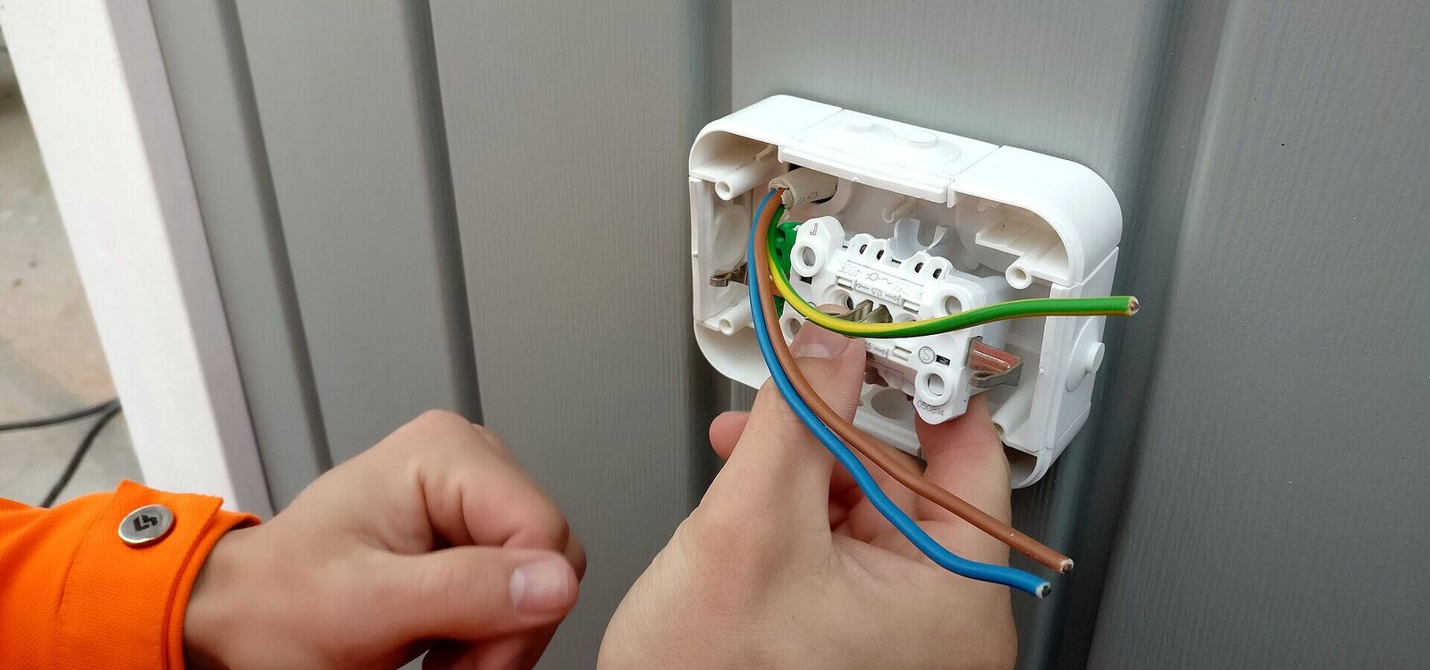 Electrician installing socket.